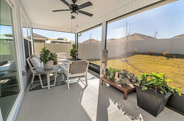 sunroom featuring ceiling fan