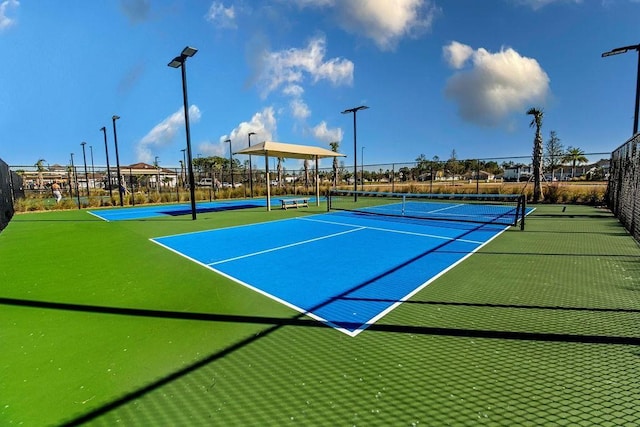 view of tennis court featuring basketball court