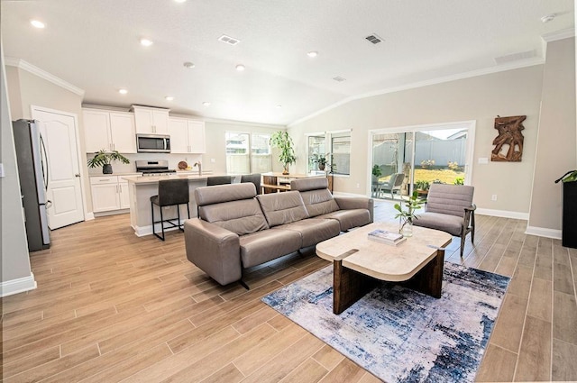 living room featuring lofted ceiling and crown molding