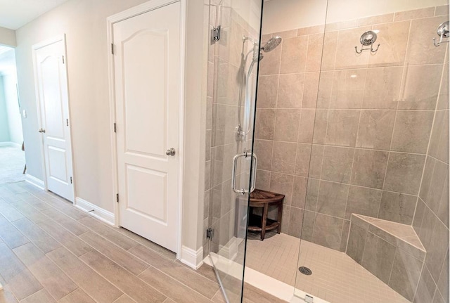 bathroom featuring walk in shower and hardwood / wood-style floors