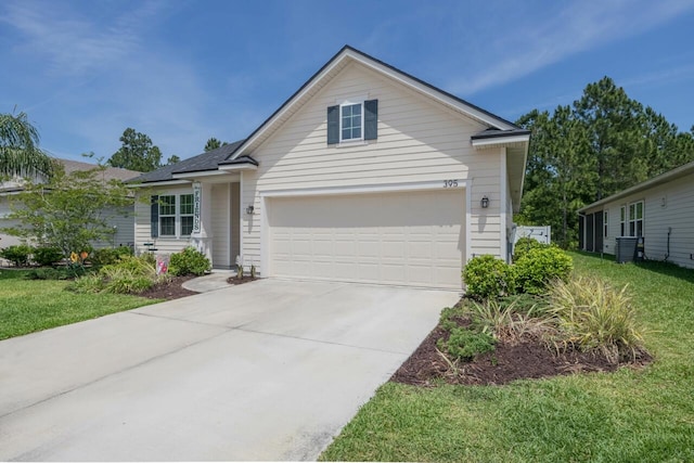 view of front of home featuring cooling unit, a front yard, and a garage