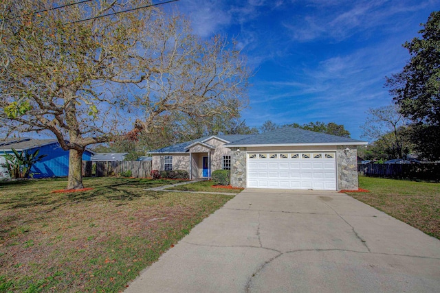 single story home with a front lawn, stone siding, fence, and concrete driveway