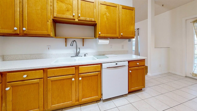 kitchen featuring light tile patterned floors, dishwasher, light countertops, open shelves, and a sink