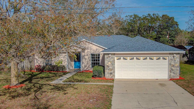 ranch-style house featuring stone siding, roof with shingles, an attached garage, and concrete driveway