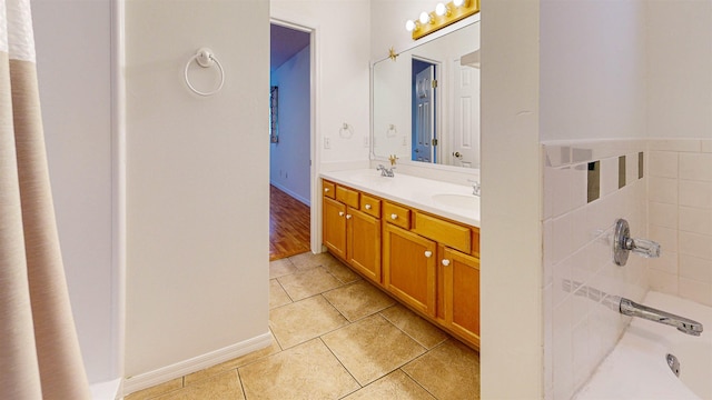 bathroom with double vanity, a sink, and tile patterned floors