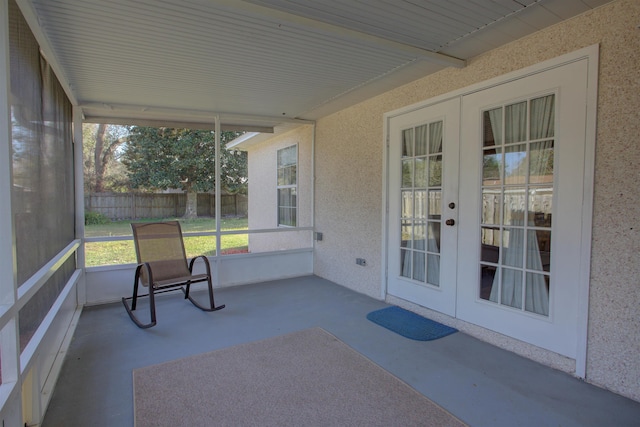 unfurnished sunroom with french doors