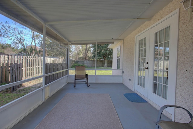 sunroom / solarium featuring french doors