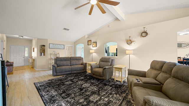 living room featuring a healthy amount of sunlight, ceiling fan, lofted ceiling with beams, and light wood-type flooring