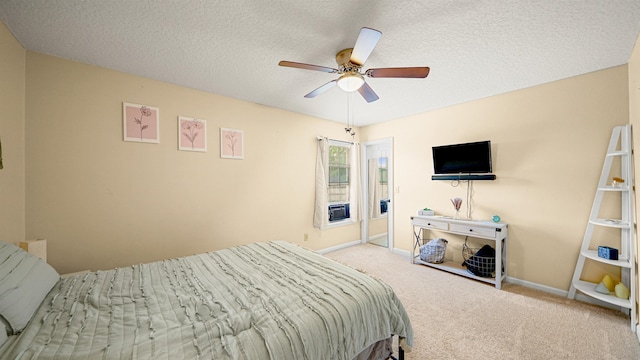 carpeted bedroom featuring a textured ceiling and ceiling fan