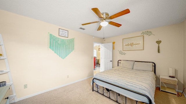 bedroom with light carpet, a textured ceiling, and ceiling fan