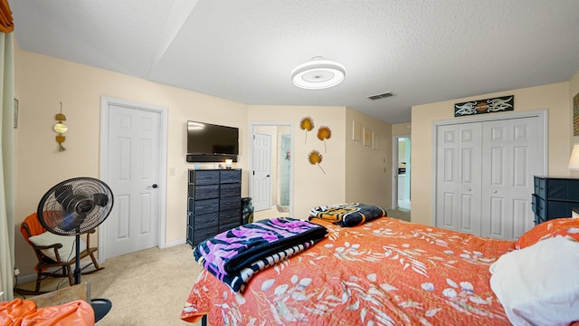 carpeted bedroom with a textured ceiling