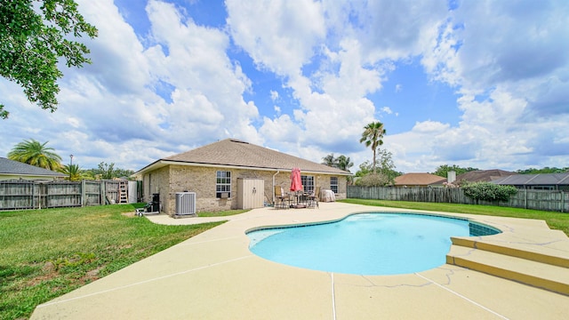 view of swimming pool featuring central air condition unit, a patio area, and a lawn