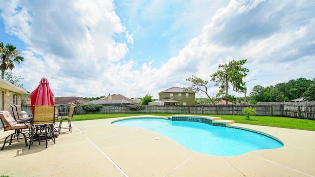 view of pool featuring a yard and a patio