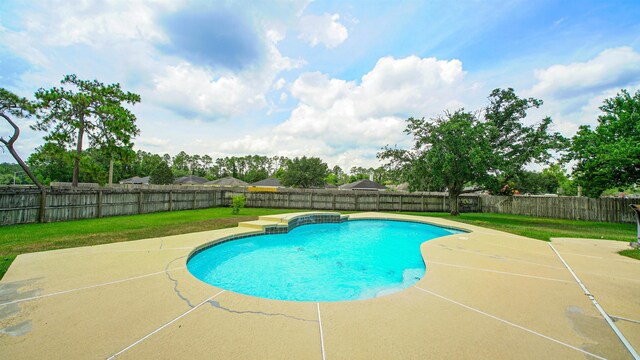 view of pool featuring a yard and a patio