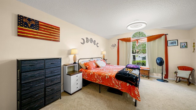 carpeted bedroom featuring vaulted ceiling and a textured ceiling