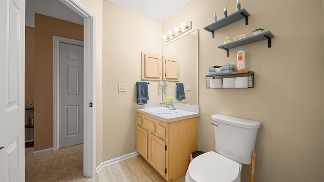 bathroom featuring hardwood / wood-style flooring, vanity, and toilet