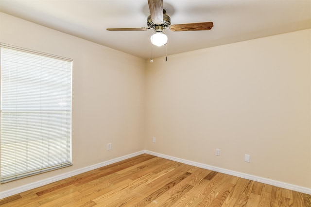 unfurnished room featuring light wood-type flooring, baseboards, a healthy amount of sunlight, and a ceiling fan