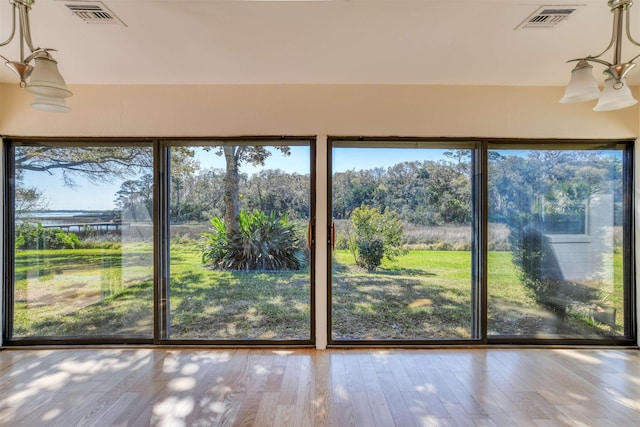 unfurnished sunroom with visible vents and a wealth of natural light