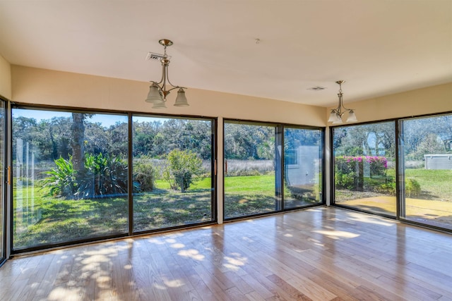 unfurnished sunroom featuring visible vents