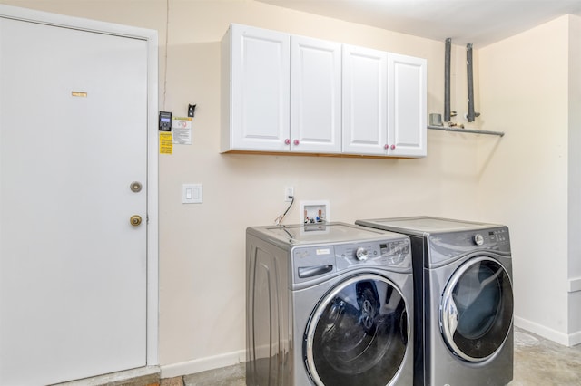 laundry room with washer and dryer, cabinet space, and baseboards