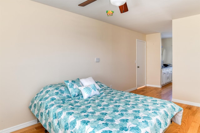 bedroom featuring ceiling fan, light wood-type flooring, and baseboards