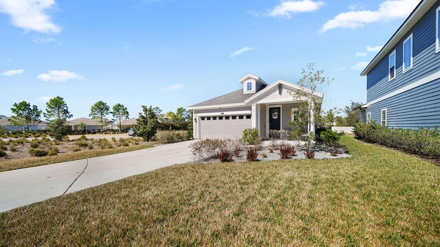 view of front of home featuring a garage, concrete driveway, and a front lawn