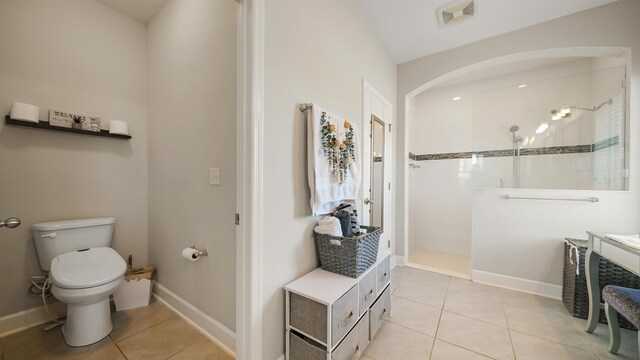 full bathroom with tile patterned floors, a walk in shower, toilet, and baseboards