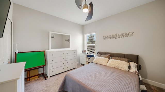 carpeted bedroom with a ceiling fan and baseboards