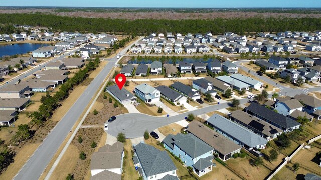 drone / aerial view featuring a residential view and a water view