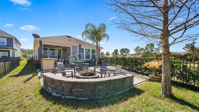 back of property featuring a fenced backyard, a patio area, an outdoor fire pit, and a lawn