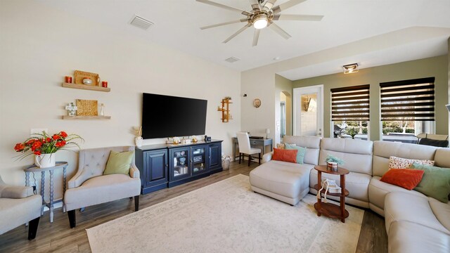 living area featuring visible vents, ceiling fan, and wood finished floors