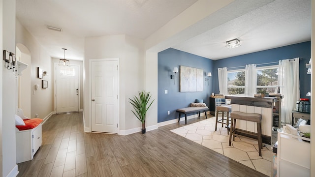 interior space featuring visible vents, baseboards, and wood finished floors