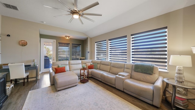 living room featuring ceiling fan, visible vents, wood finished floors, and vaulted ceiling