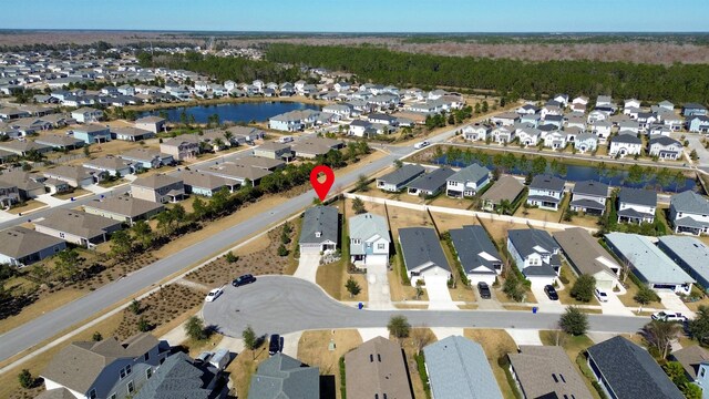 drone / aerial view with a residential view and a water view