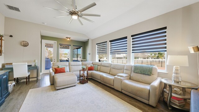 living area featuring visible vents, a healthy amount of sunlight, and wood finished floors