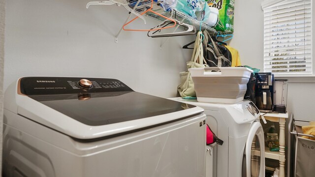 clothes washing area with washer and dryer and laundry area