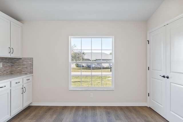 interior space with baseboards and wood finished floors