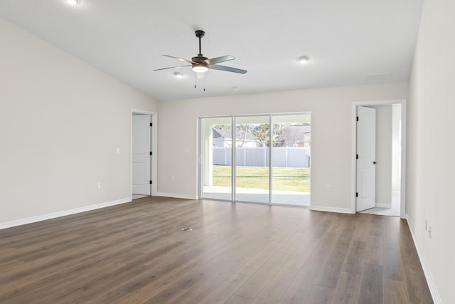 unfurnished room with lofted ceiling, a ceiling fan, dark wood-style flooring, and baseboards