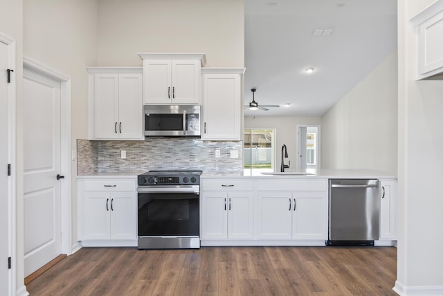 kitchen featuring a ceiling fan, a sink, white cabinetry, appliances with stainless steel finishes, and light countertops