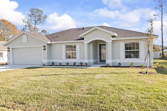 ranch-style home with driveway, an attached garage, roof with shingles, and a front yard