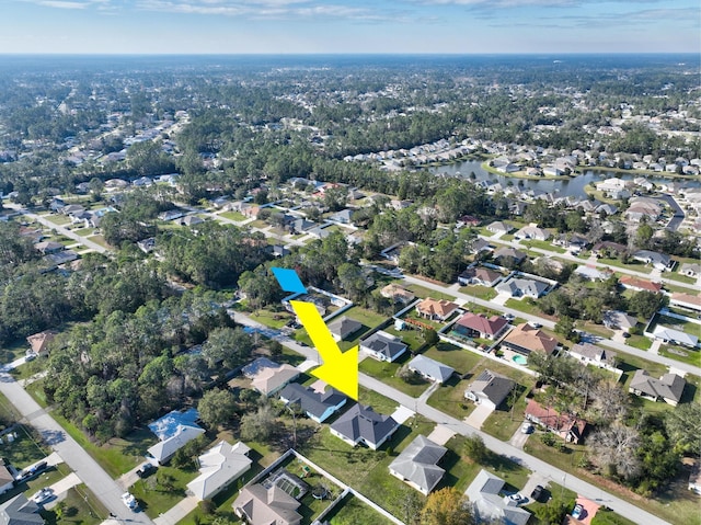 bird's eye view with a residential view and a water view