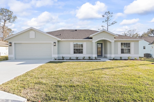 ranch-style home featuring a front lawn, central AC, roof with shingles, a garage, and driveway