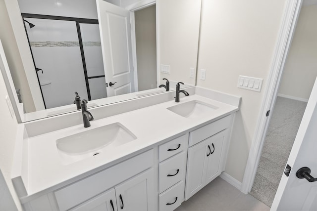 full bathroom featuring a sink, a stall shower, and double vanity