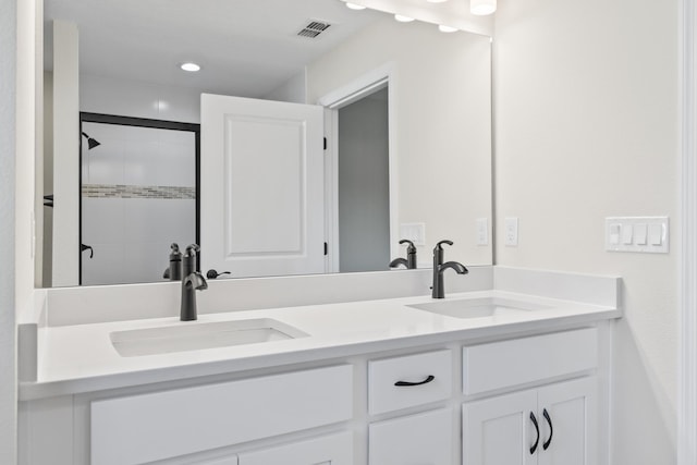 bathroom featuring a sink, visible vents, double vanity, and a shower stall