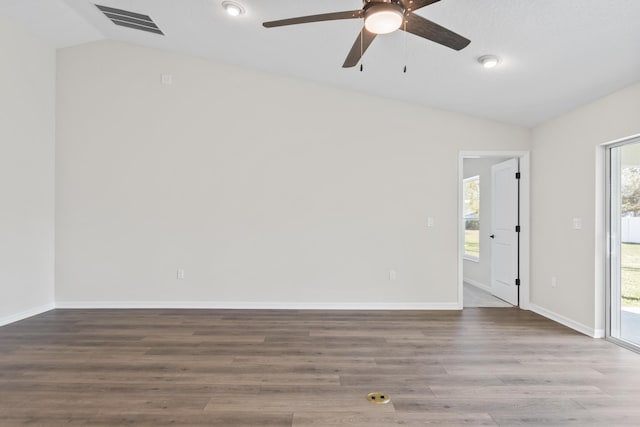 unfurnished room featuring visible vents, ceiling fan, baseboards, lofted ceiling, and wood finished floors