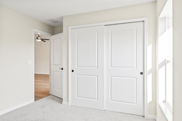 unfurnished bedroom with a closet, baseboards, and carpet