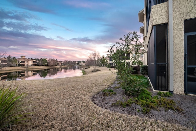 yard at dusk with a water view