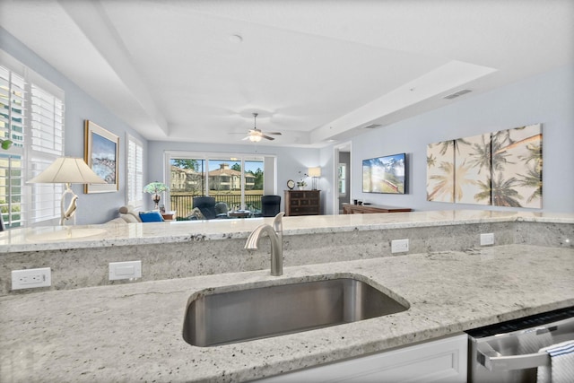 kitchen featuring visible vents, dishwasher, open floor plan, a tray ceiling, and a sink