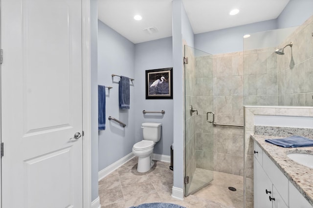 bathroom featuring toilet, a shower stall, baseboards, and vanity