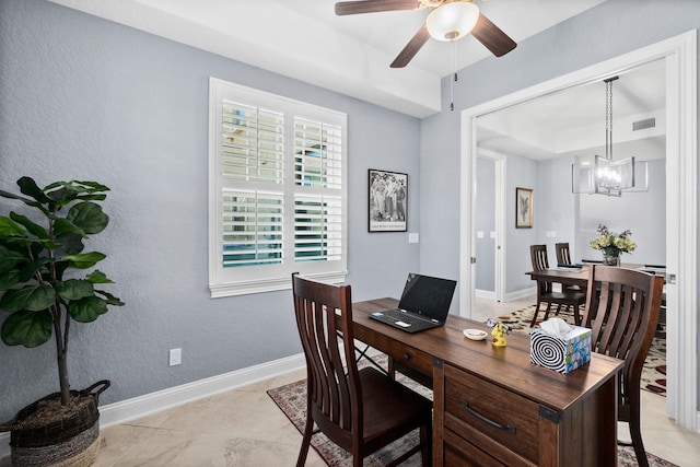 home office with visible vents, baseboards, a tray ceiling, and ceiling fan with notable chandelier